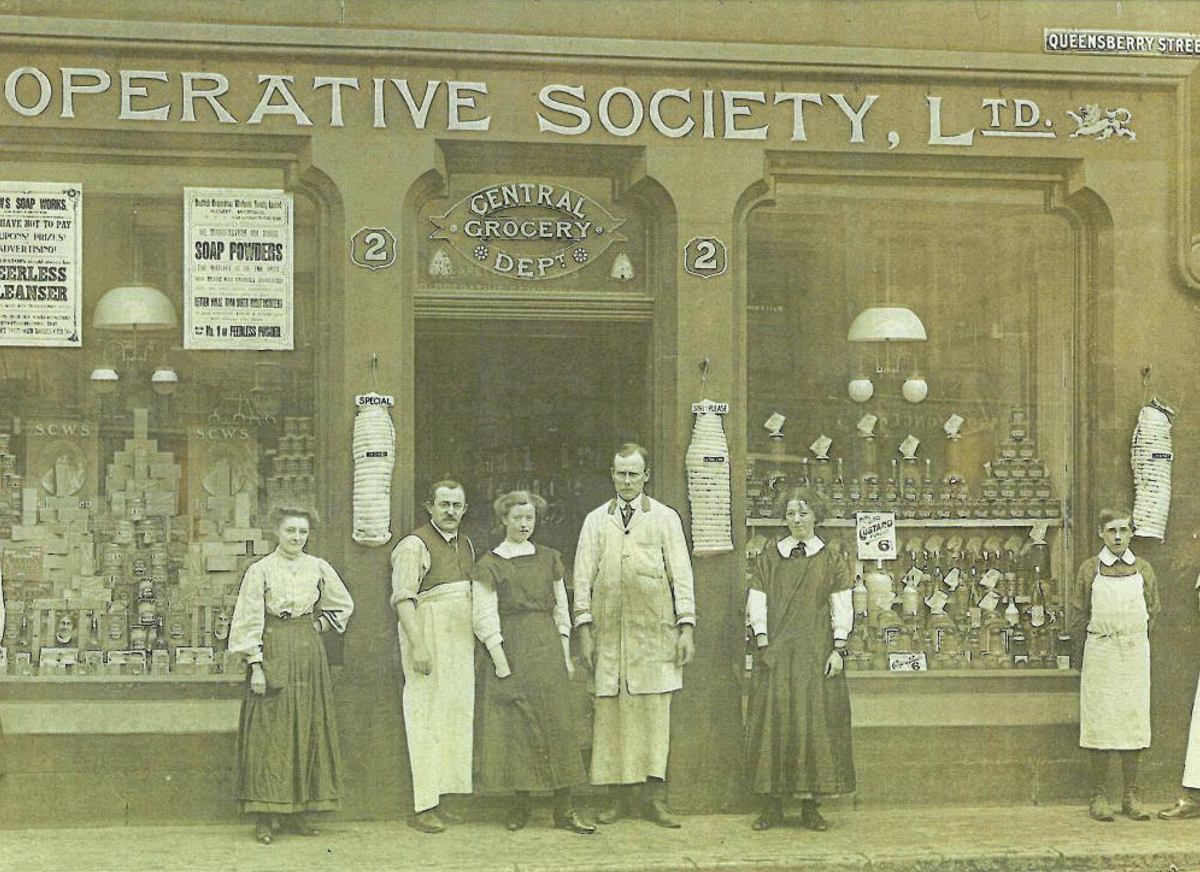 People standing in front of business named 'Cooperative Society Ltd'